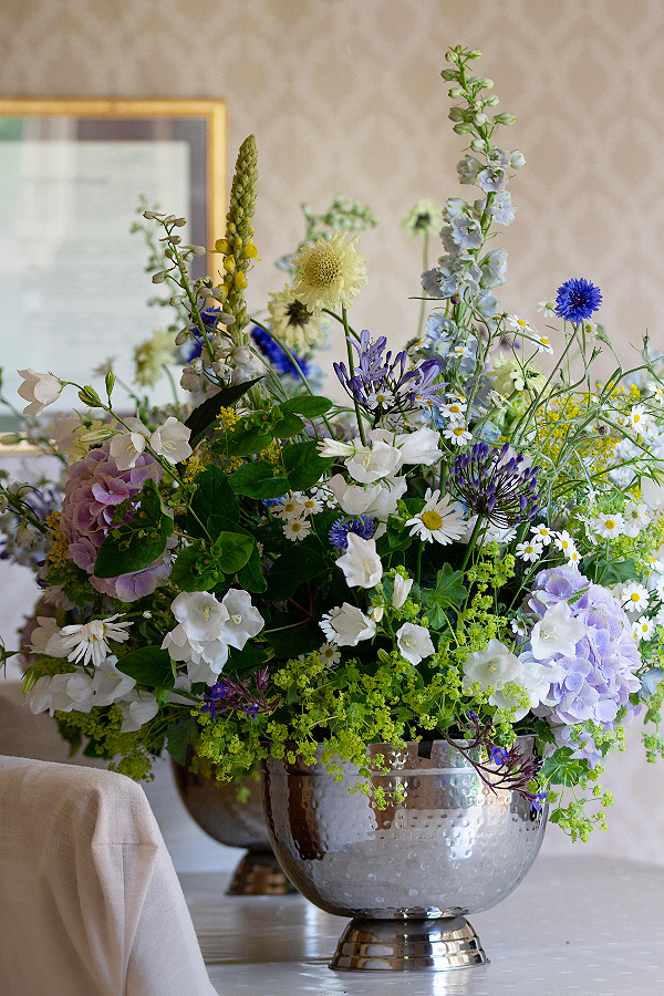 Event flowers for a central Birmingham graduation ceremony. Summer flowers in blues, yellows and whites fill large silver punchbowls.